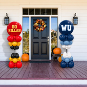 Two large balloon column decorations on a front porch. The left column is red, yellow, and black with the text 'GO RILLAS!'.