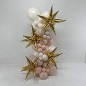 Balloon sculpture with gold stars and white and pink balloons on a white background